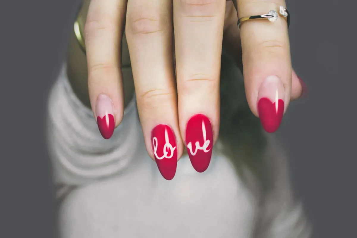 Neutral manicure with fine gold nail art detail.