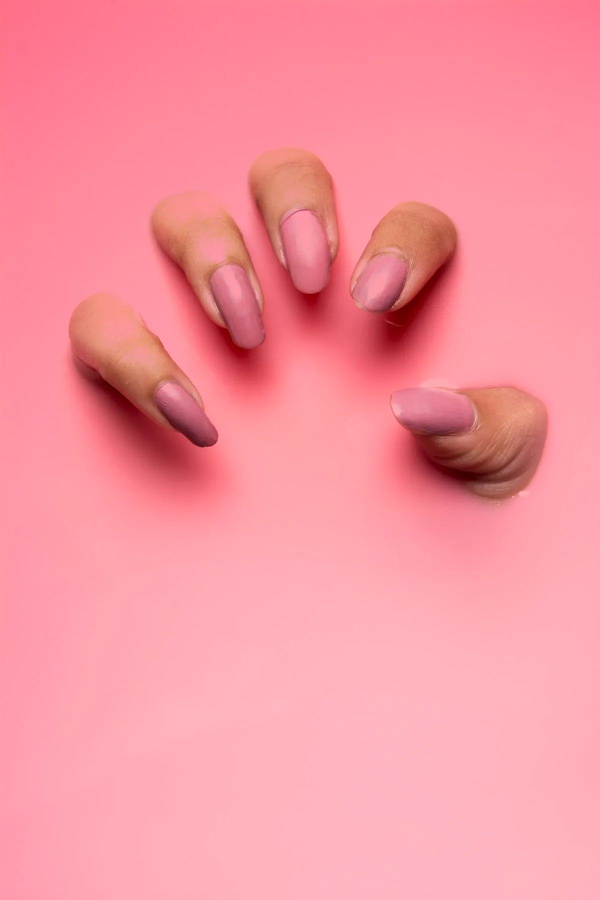 Long gel extension set photographed against a soft beige background.