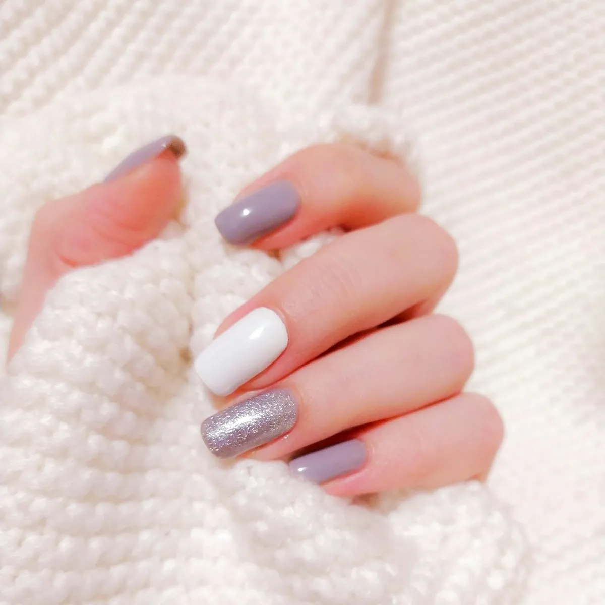 Soft blush manicure with almond-shaped nails and glossy finish.
